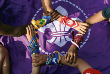 International patch with fleur de lise on a purple background and five hands linked together