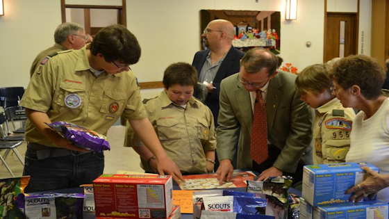 Image of adults and scouts reviewing a popcorn order